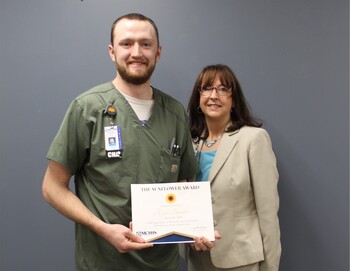 Sunflower Award Honoree Ryan Shrader, CNA and Janelle Kircher smiling.